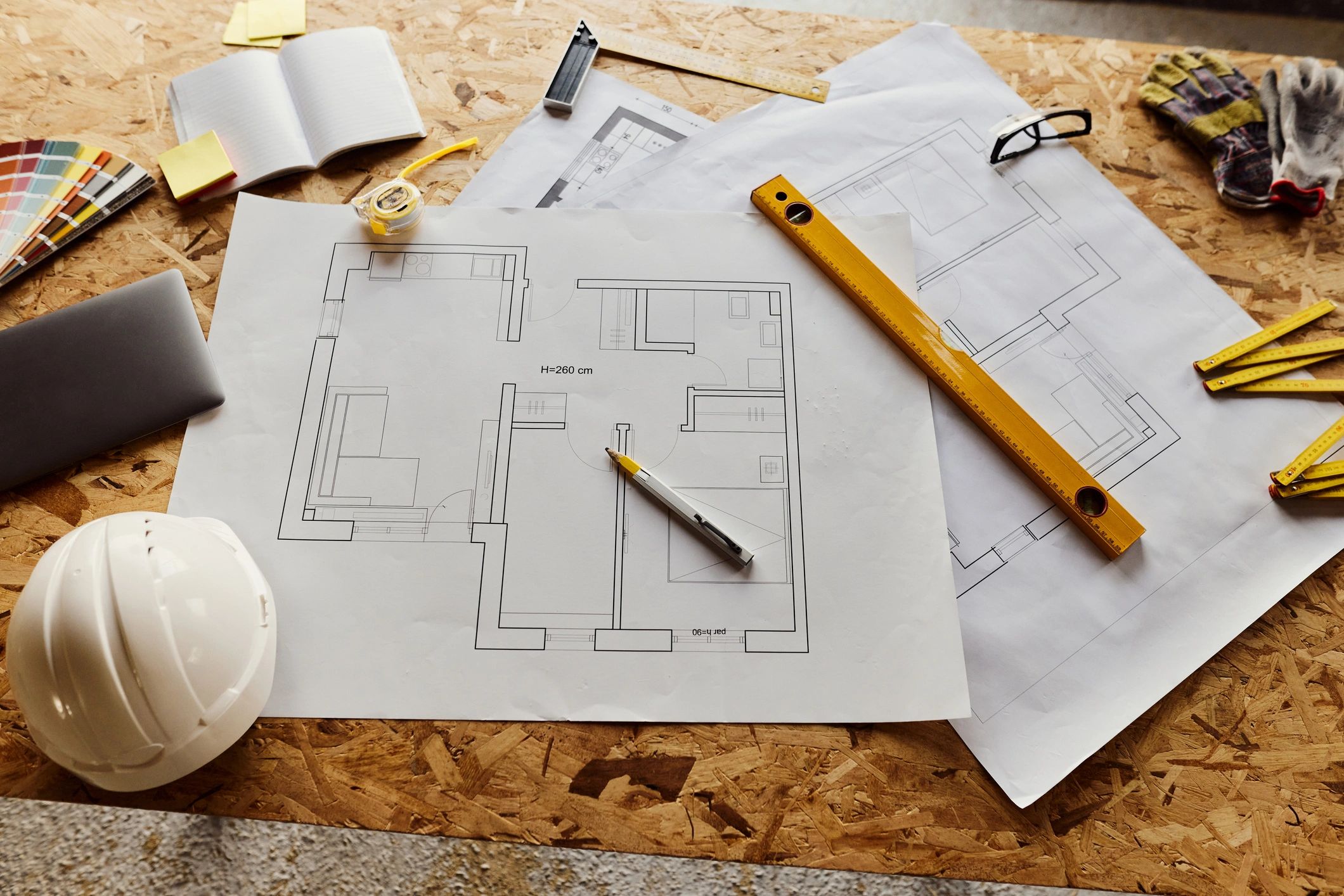 Blueprints and construction tools representing disciplined underwriting and development planning