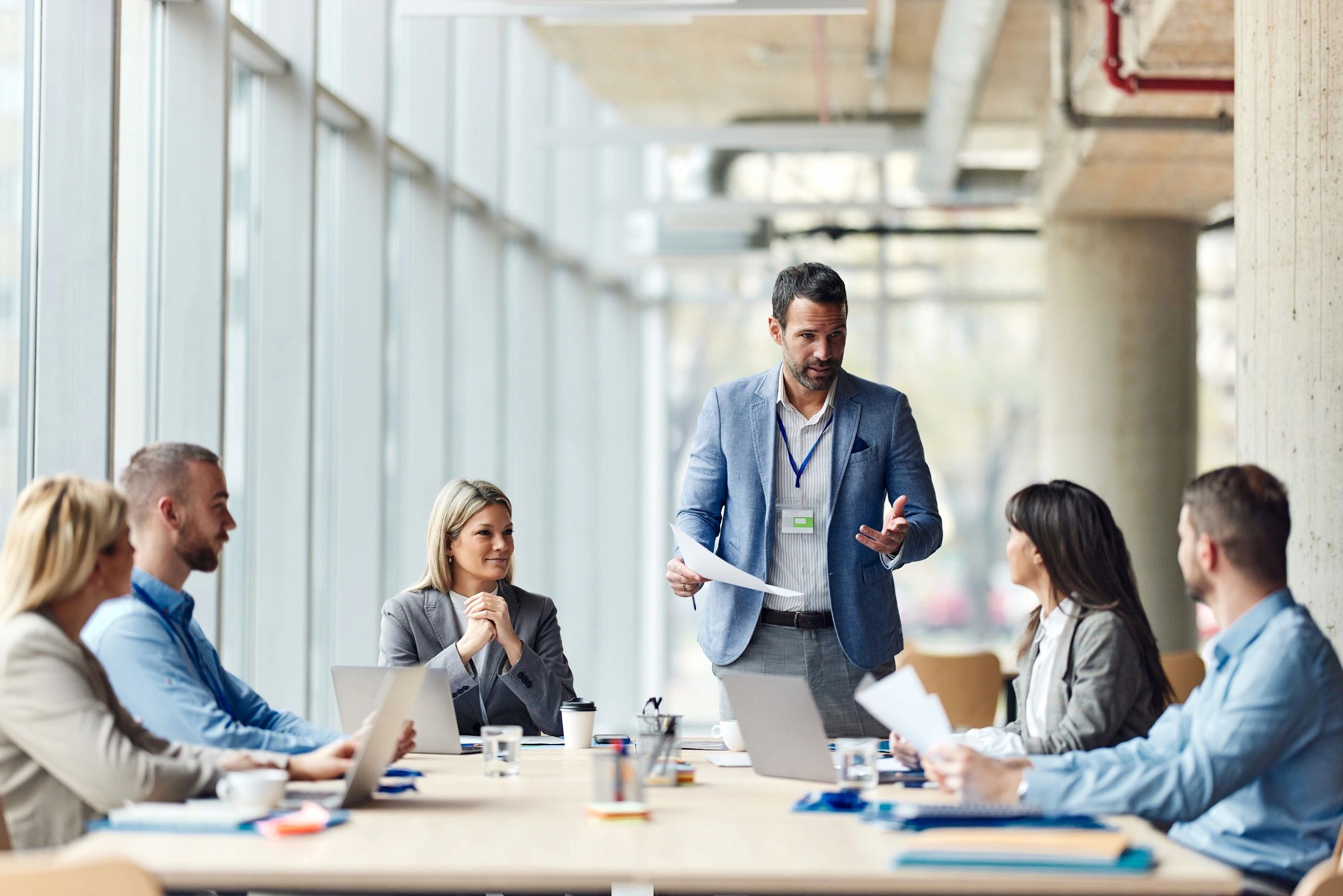 Executive speaking with team in an office meeting