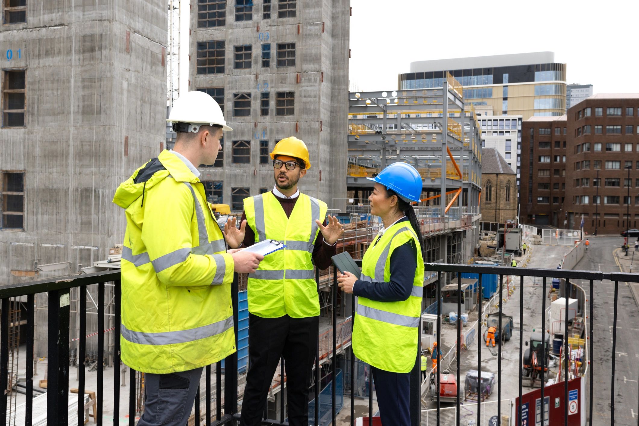 Construction professionals reviewing plans at a development site